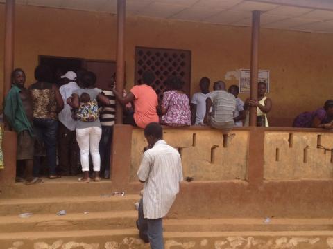 A queue of impatient registrants outside the registration center at Congo Town