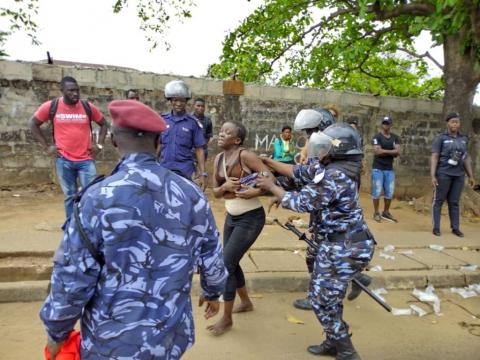 An APC supporter being taken away