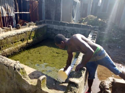 An algae infested reservoir where Docorty community people fetch their drinking water