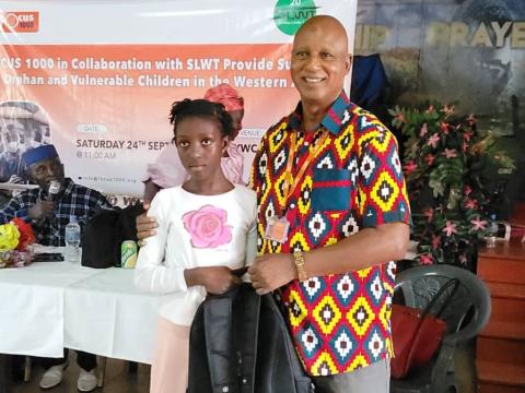 Alhaji Mohamed Bailor Jalloh, handing over school materials to Ebola and Mudslides survivors