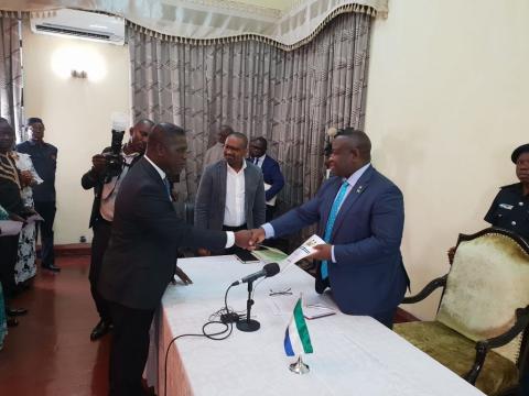 Sierra Leone's Chief Minister Prof David Francis (L) hands over the Transition report to President Julius Maada Bio