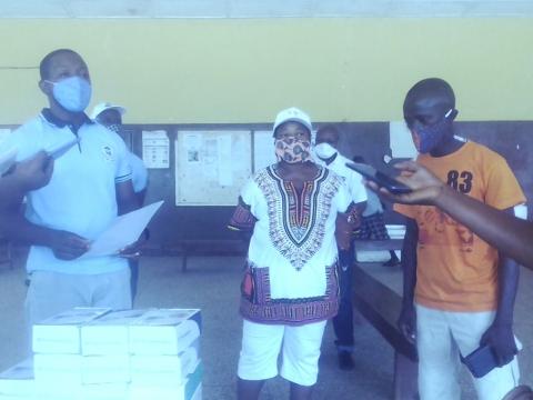Dr Grant receiving the items