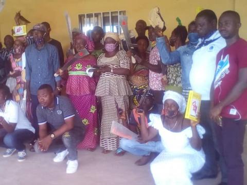 Farmers pose with donated farm implements from BRAC