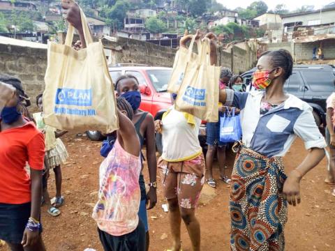 Girls showing off their sanitary kits