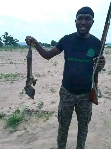 Hunter Foday Mansaray with recently shot fruit bat in Kasseh village, near Port Loko. 