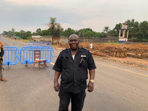 Officer-In-Charge, AB Kamara of the SLP poses in front of a checkpoint between Western Area and Port Loko District.-1