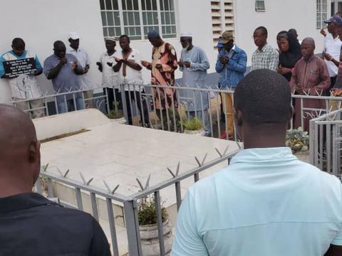 Prayers being offered by Dr Khan's graveside