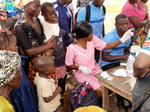 Residents of Kaboreh Village in Karene District line up to be tested for malaria by health workers as part of the Global Fund supported Static Campaign. Photo credit, Kemo Cham