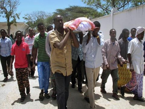 Friends and relatives carry the coffin of Abdisatar Dahir Sabriye, a well known Somali journalist with state-run television killed in suicide bomb attack, Sept. 21, 2012. (AP Photo/Mohamed Sheikh Nor)