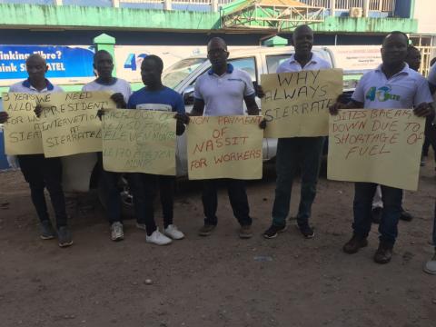 Sierratel angry staff displaying placards at the headquarters in Freetown