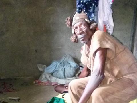 A herbalist performing a ceremony on the corpses before burial