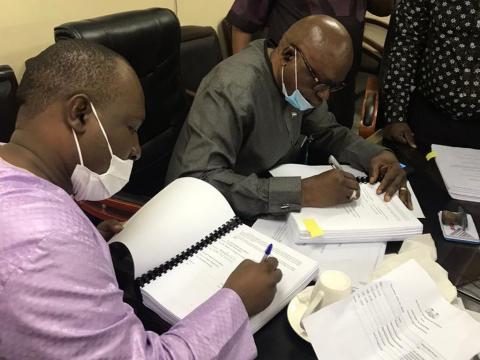 Transport Minister Kabineh Kallon signing contrcat with a representative of PAVIFORT